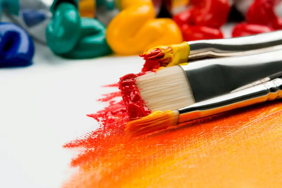 Paint brushes and colourful paint used to create artwork for Turn Paper into Trees